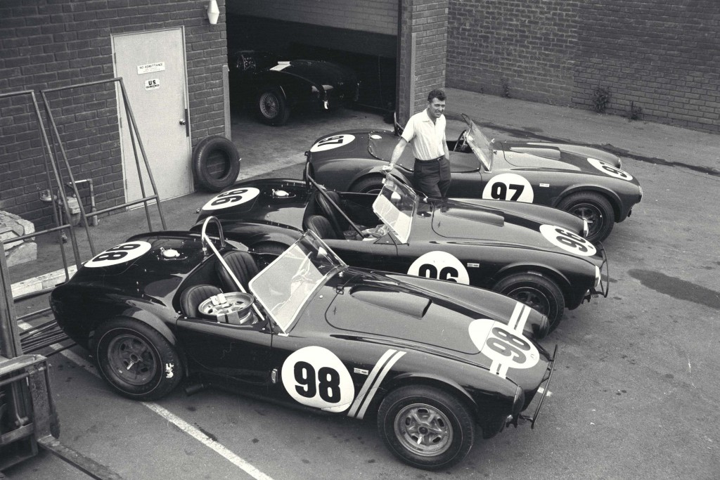 Carroll Shelby poses with three roadsters in California, 1963.