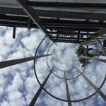 Looking up ladder into clouds and sky