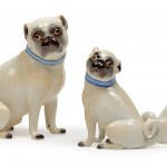 Lot 900. Large and small pug and a small female pug with light blue collars.